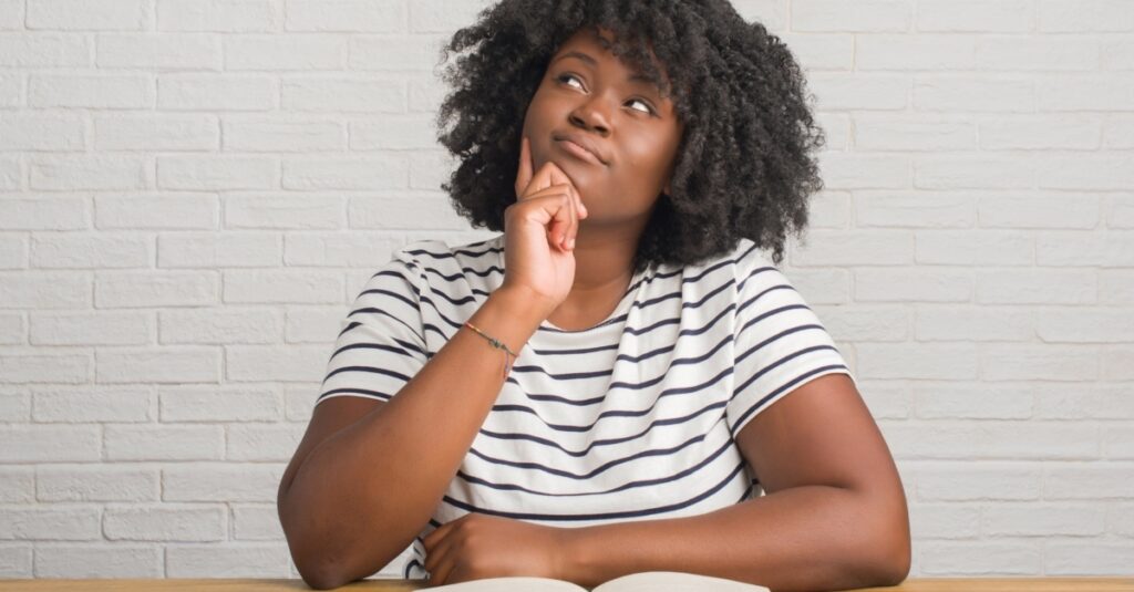 14760-woman-looking-up-and-questioning-what-is-in-b