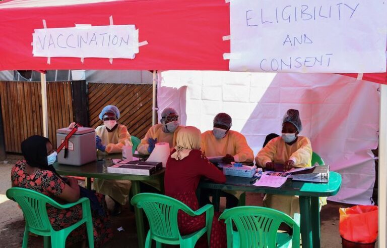 Ugandan doctors attend the contacts of a patient who had tested positive, during the launch of the vaccination for the Sudan strain of Ebola virus, in Kampala