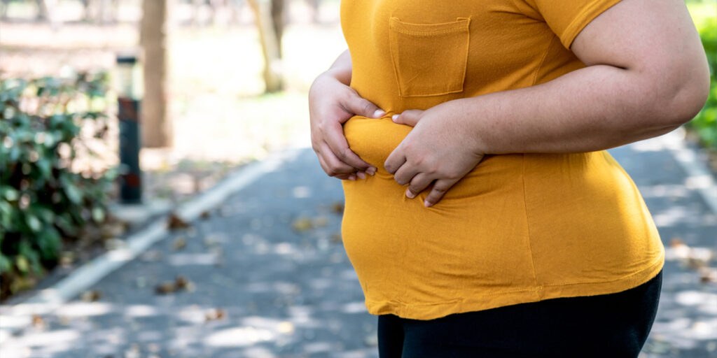 obese-woman-holding-her-fat-obesity